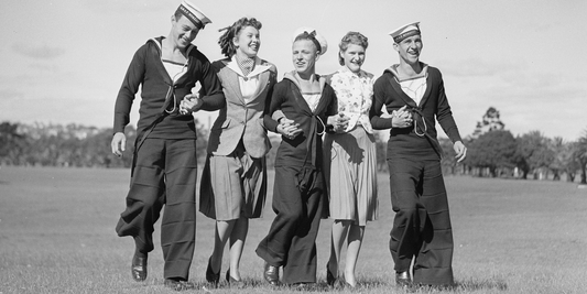 Group of sailors and young women walking together in Sydney during the 1940s, capturing friendship and everyday Australian life.