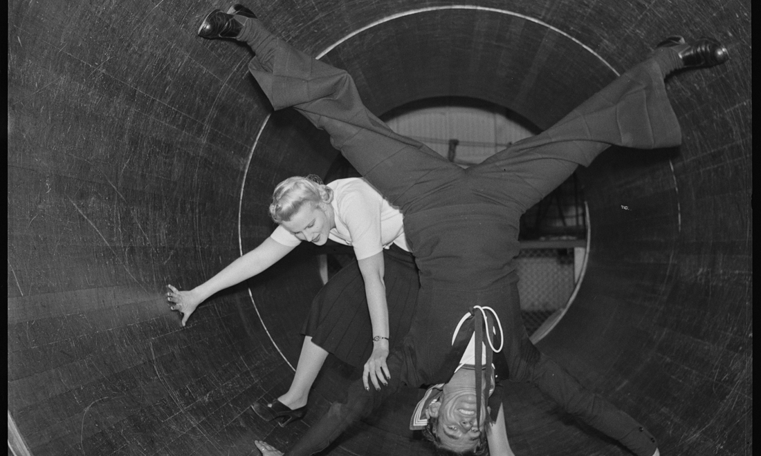 Sailors and visitors enjoying the spinning barrel ride at Luna Park Sydney during the 1940s.