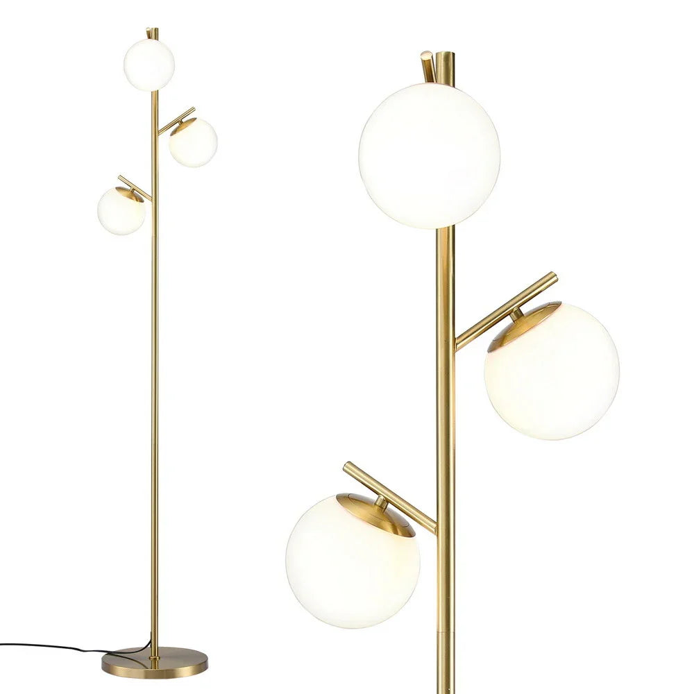 Modern gold floor lamp with three frosted glass globe lights on a sleek metal stand
