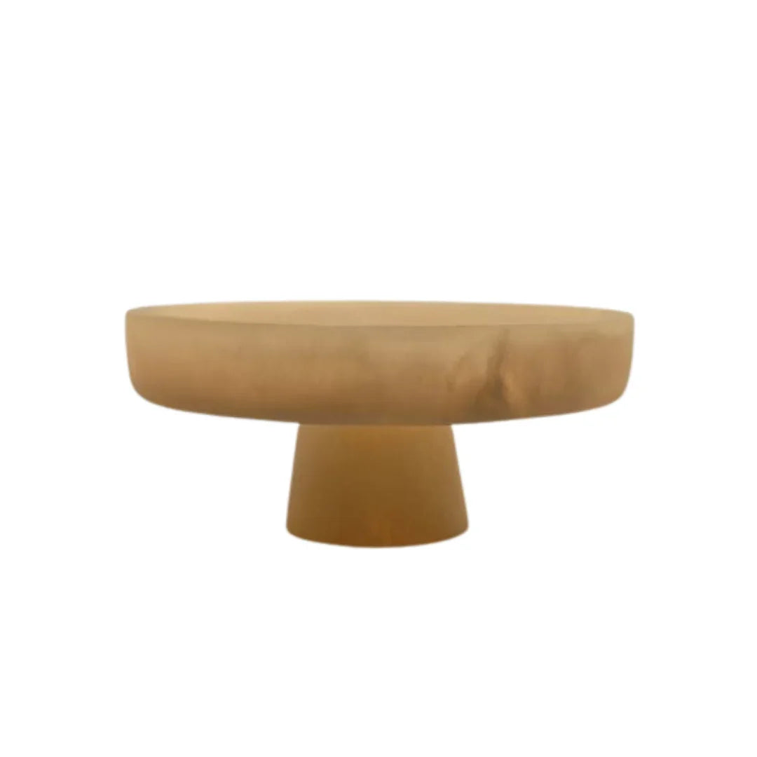 Modern round beige pedestal table with a smooth, minimalist design on white background