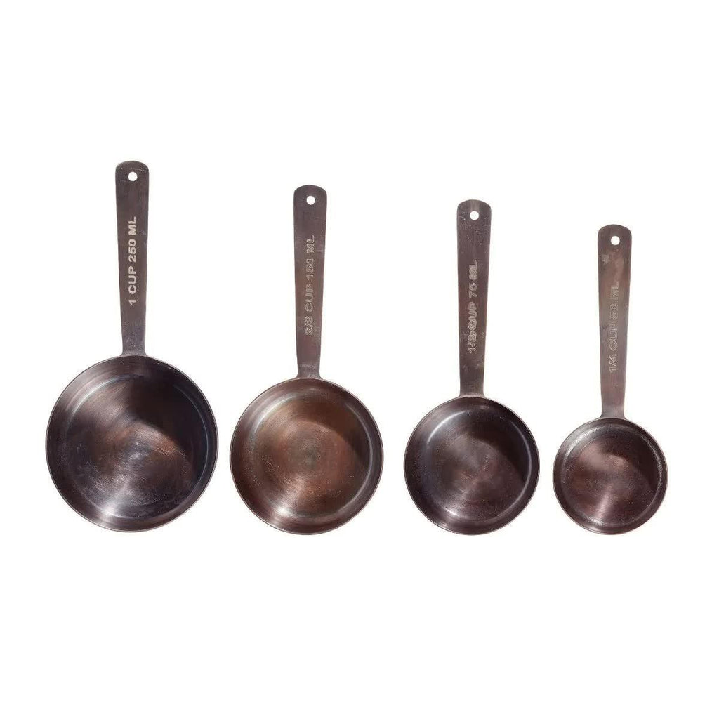 Set of four stainless steel measuring cups on white background, labeled with cup and ml sizes