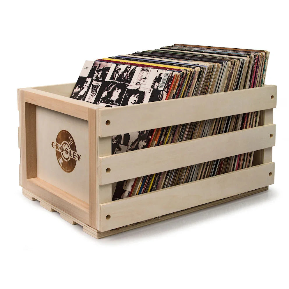 Crosley wooden record crate filled with vinyl records on white background