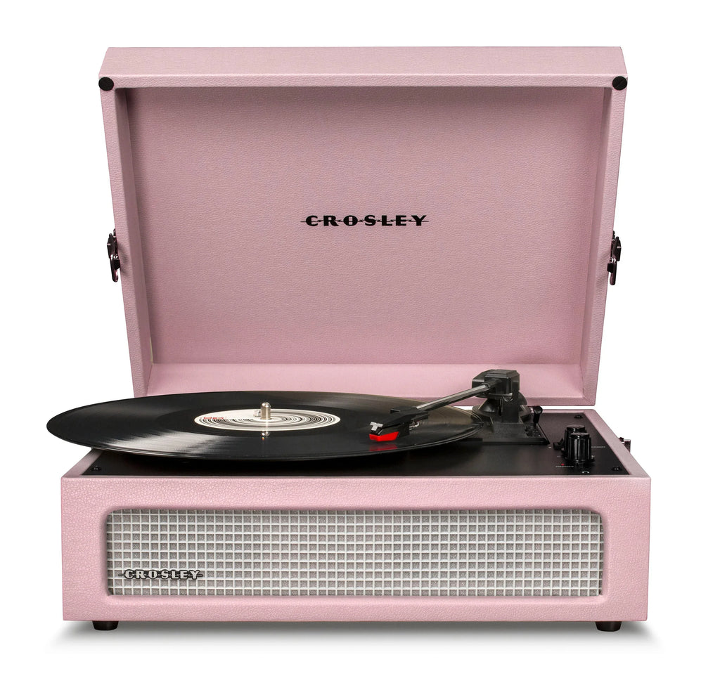 Pink Crosley record player with vinyl on turntable, open lid, front speaker visible
