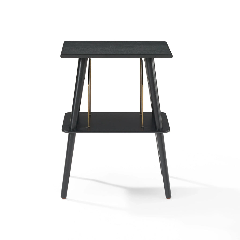 Modern black wooden side table with two tiers and gold metal accents on white background