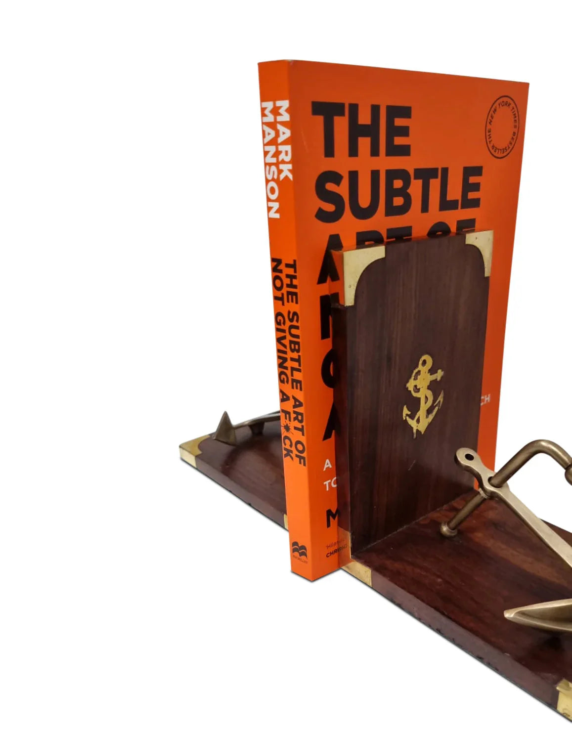 Wooden nautical anchor bookends with brass accents holding an orange book