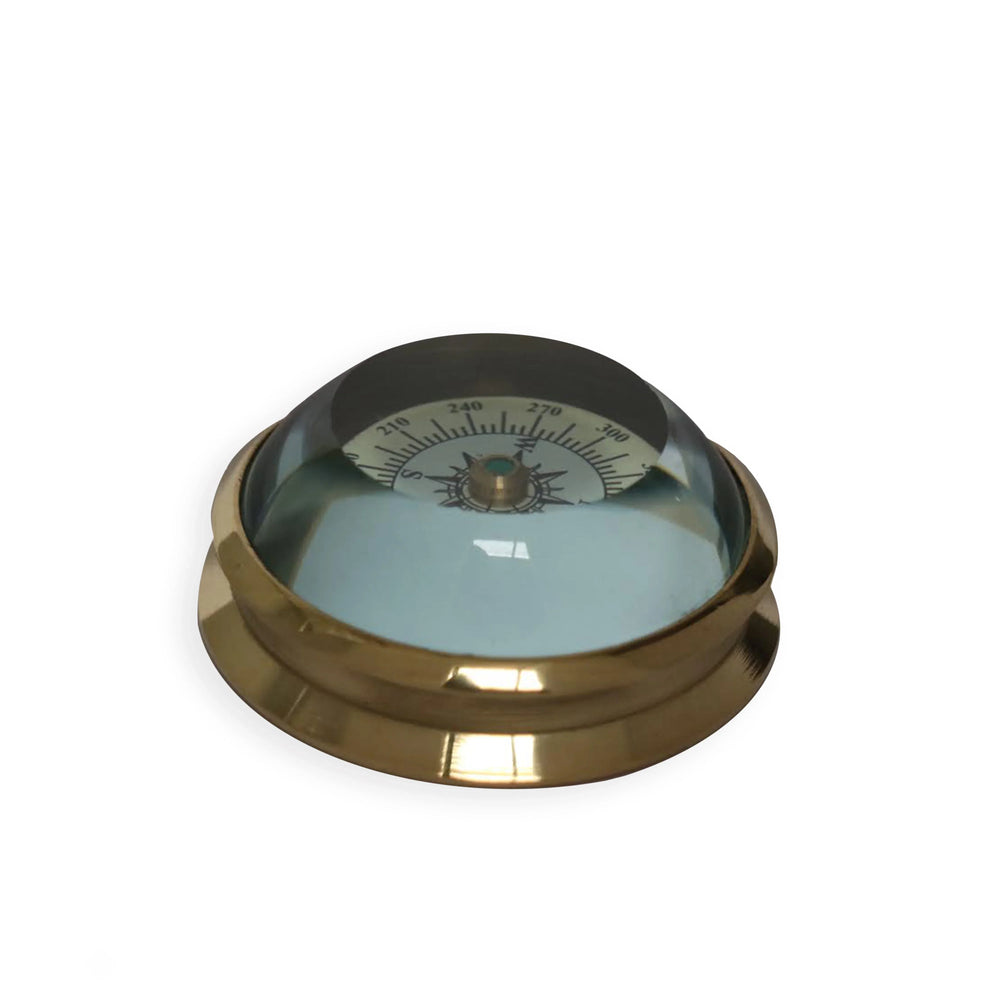 Brass dome marine compass with glass cover on white background