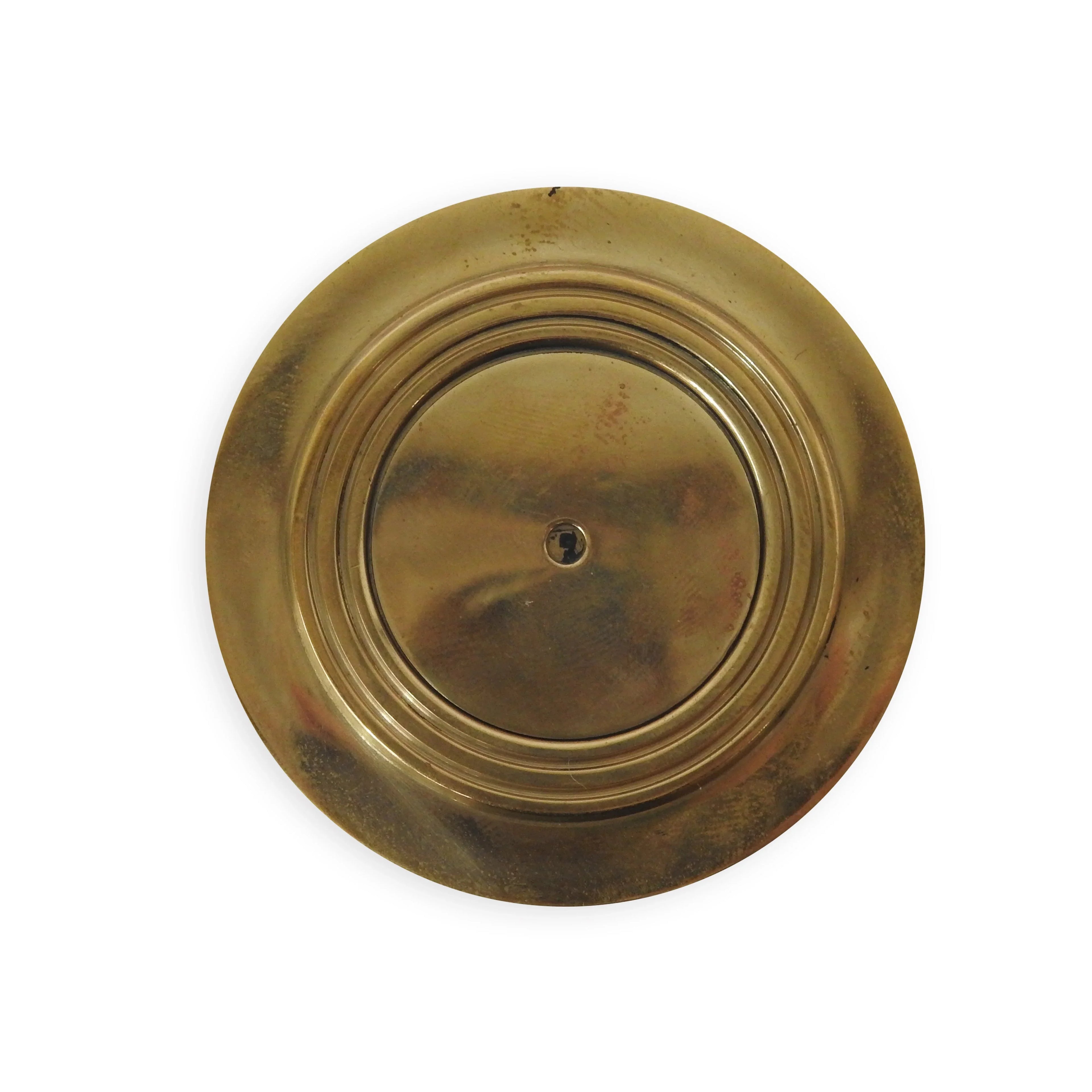 Round brass keyhole cover with concentric circles on white background