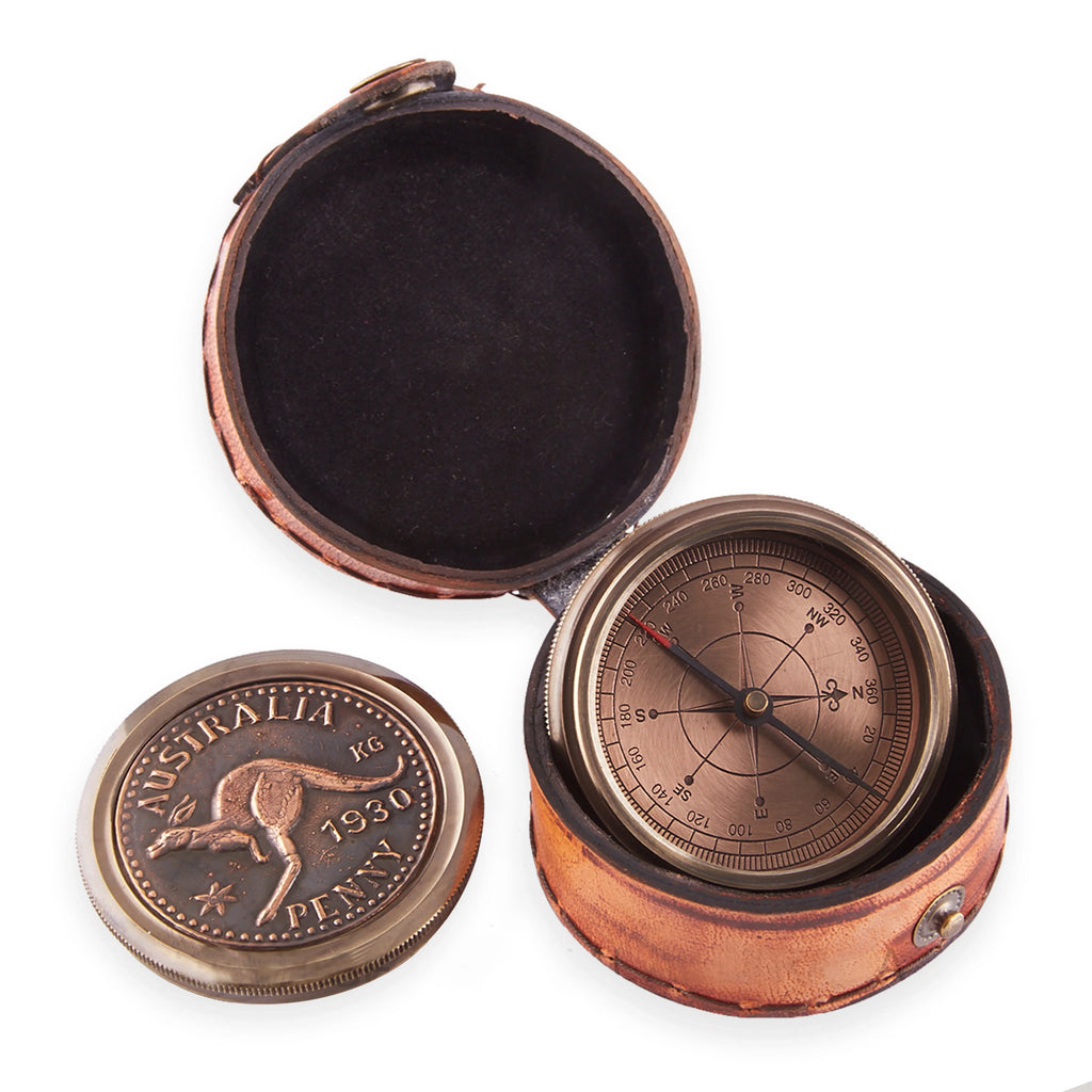 Vintage brass compass with Australia 1930 penny cover in a brown leather case