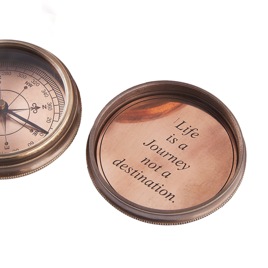 Vintage brass compass with engraved lid reading 'Life is a Journey, not a destination.'