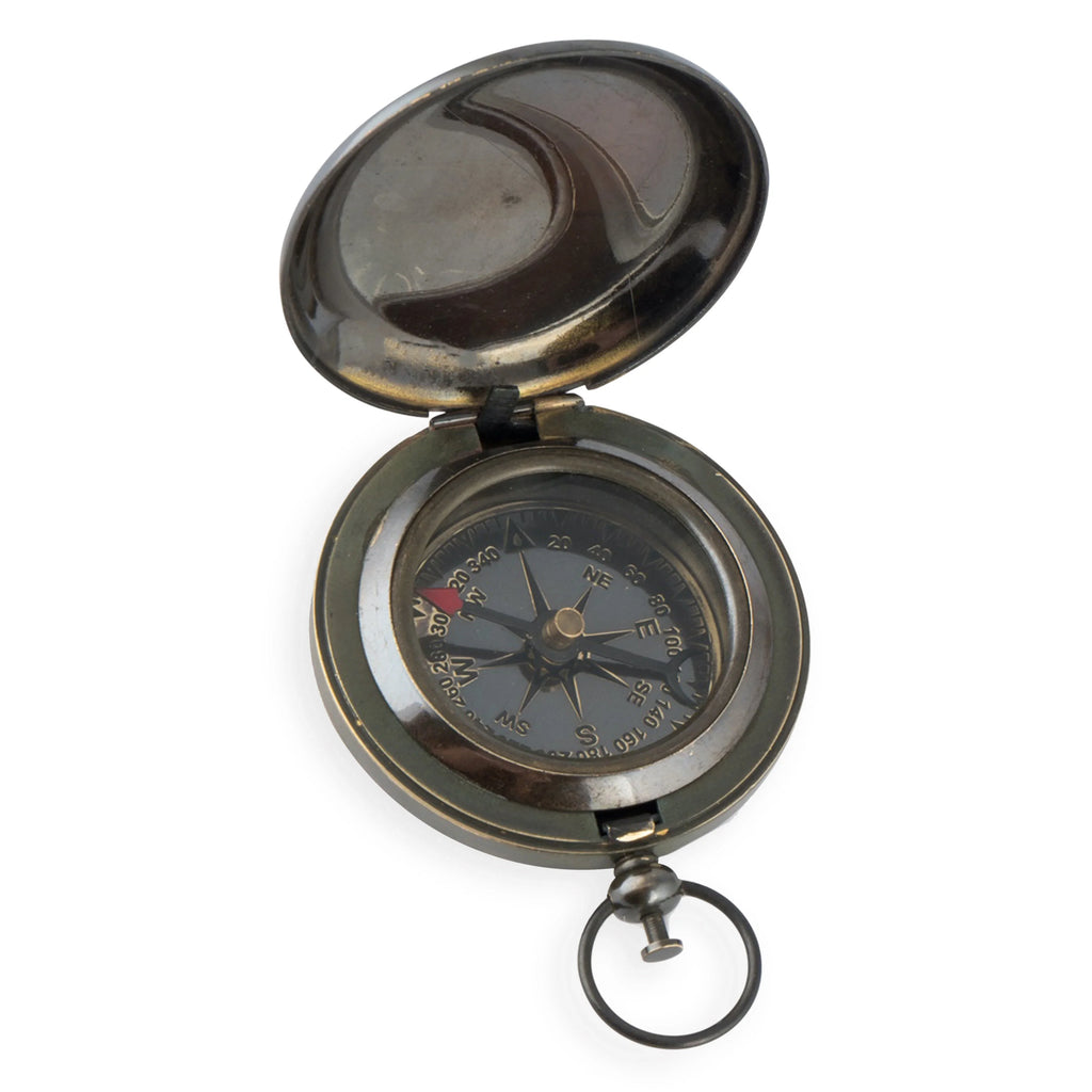 Vintage brass pocket compass with open lid and keyring on white background