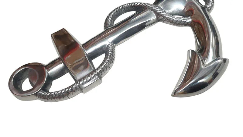 Polished chrome anchor with rope, nautical decor on white background