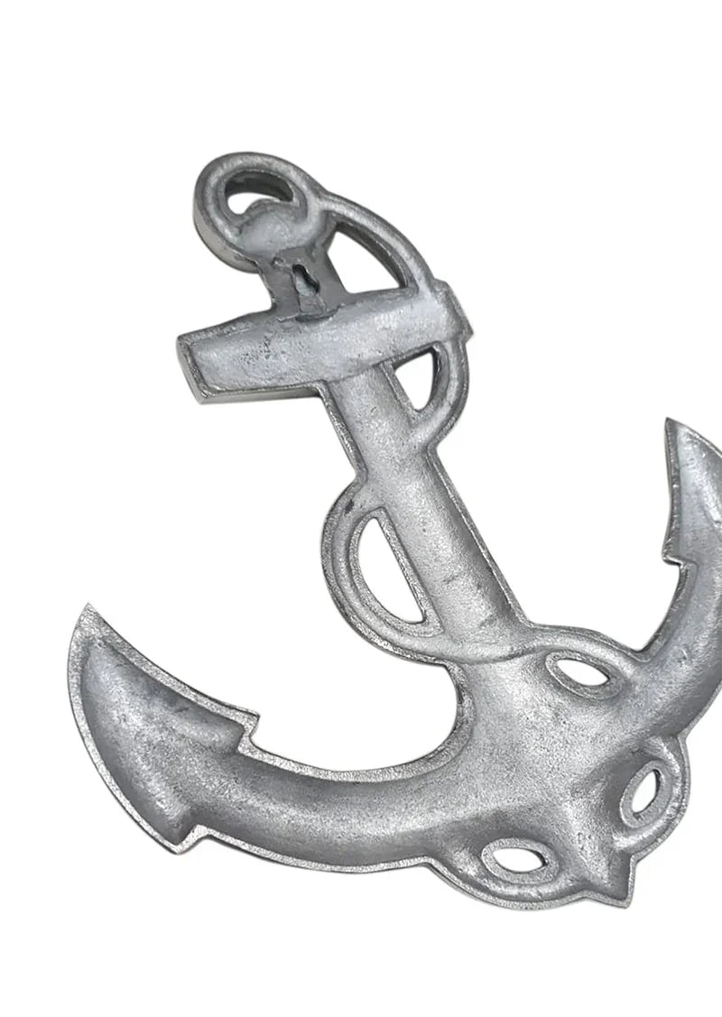 Silver decorative metal anchor with cutout details on a white background
