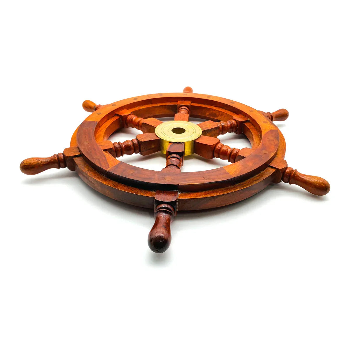 Wooden ship wheel with brass center on white background, nautical decor