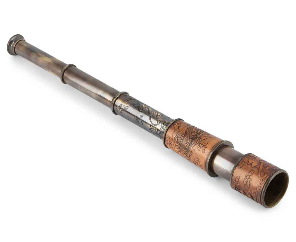 Vintage brass and copper handheld telescope with ornate engraved patterns on the barrel