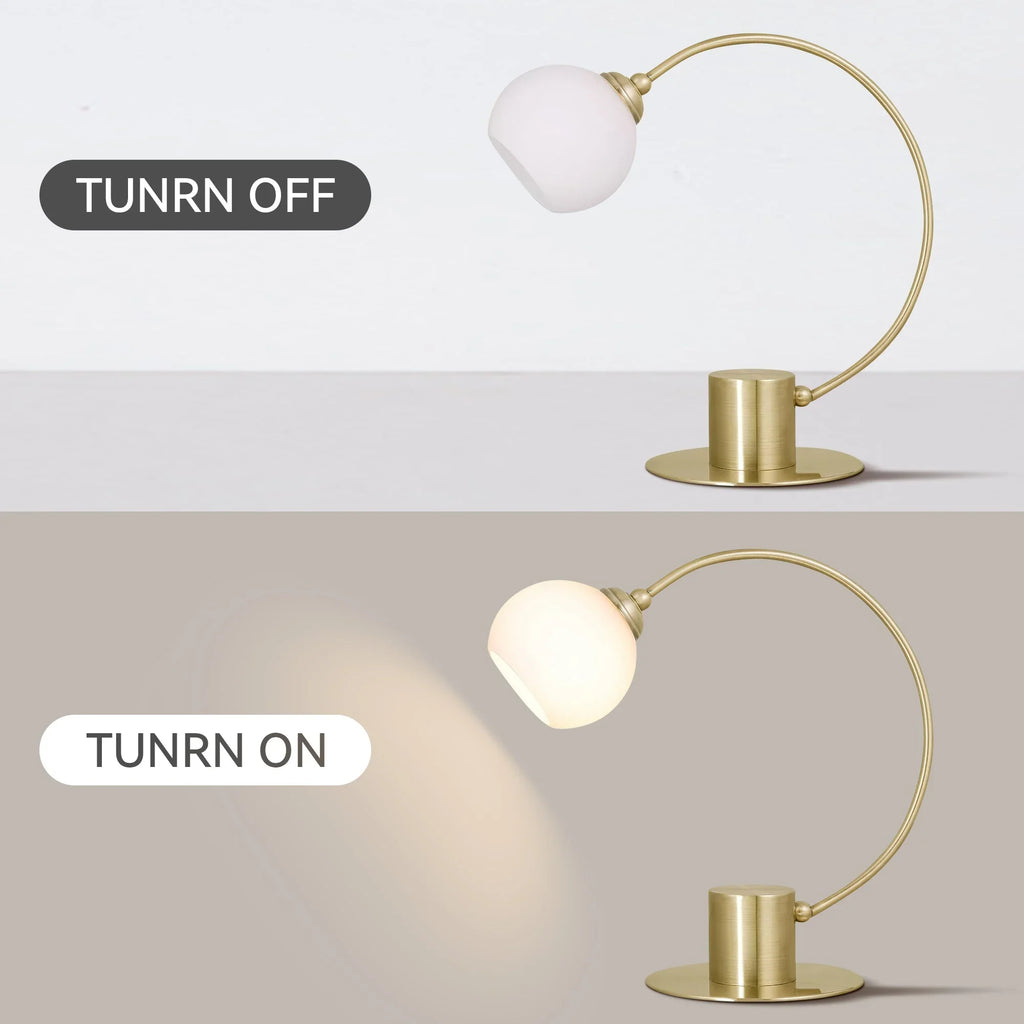 Modern brass table lamp with frosted globe shade shown turned off and on